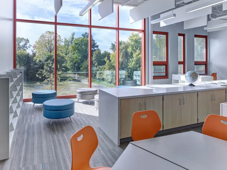 A room with tables, chairs and cubbies inside the Columbus Spanish Immersion Academy