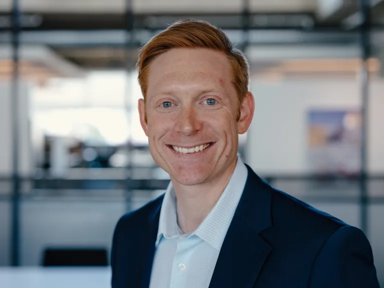 David Sparling smiling, wearing a navy blazer and white shirt