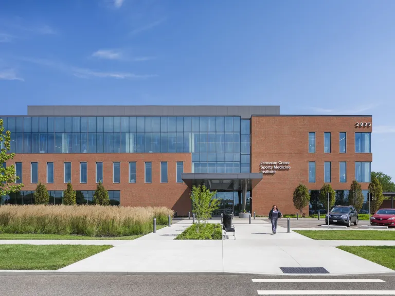 Exterior of Jameson Crane Sports Medicine Institute during the day, a large brick building with large floor to ceiling windows