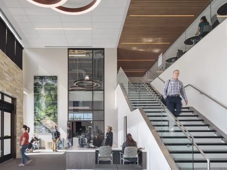 Atrium of River Valley Campus featuring a large staircase and modern circular lighting above a lounge space