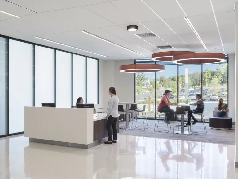 Interior modern lounge with floor to ceiling windows and circular lighting above