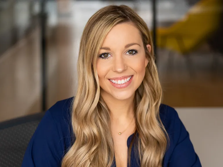 Kaitlyn Voelker smiling, wearing a navy blue blouse