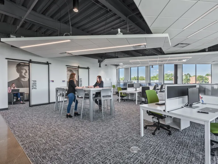 Open concept desk space with a workstation table in the center