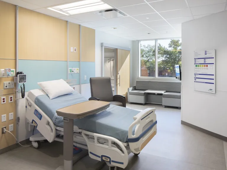 Mercer Health inpatient room with light wood and light blue walls