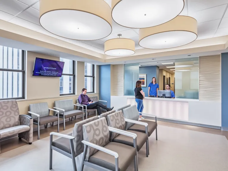 Mercy Hospital check in and waiting room featuring beige and light blue walls and lights