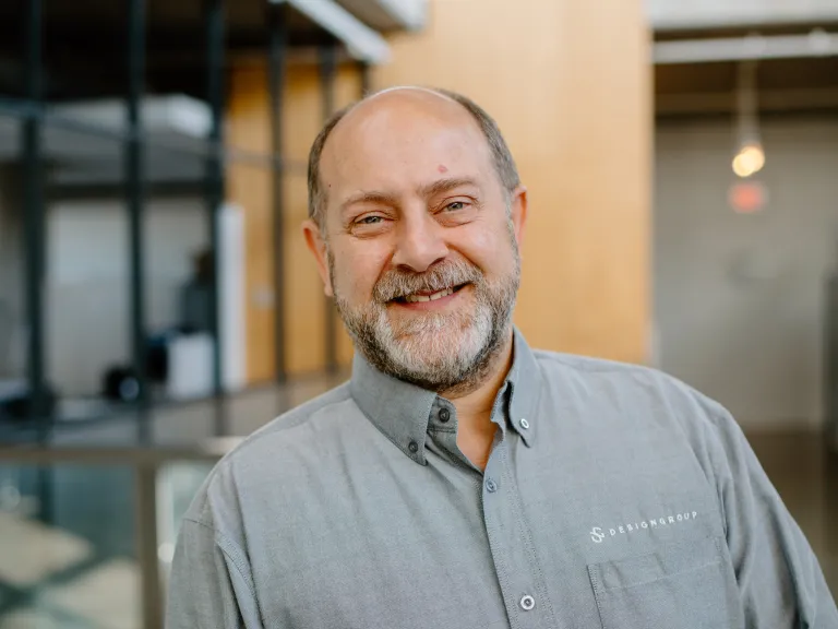 Michael Chervenak smiling, wearing a light gray button down