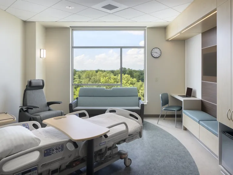 Interior of patient room with light teal accent furnishing