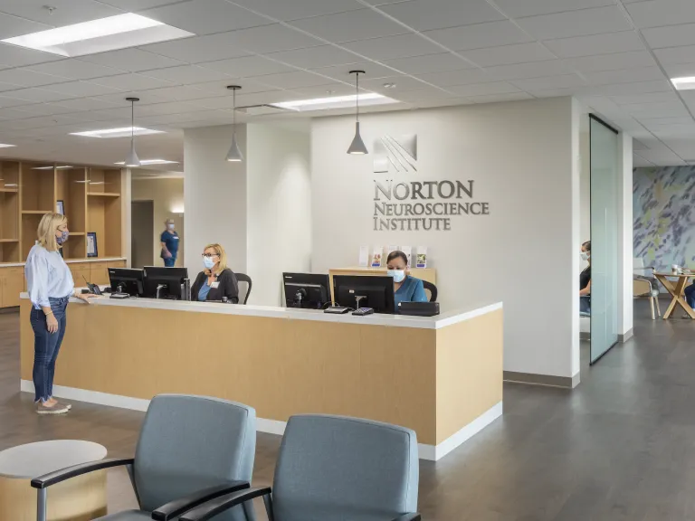 Norton Neuroscience Institute front desk with light wood paneling