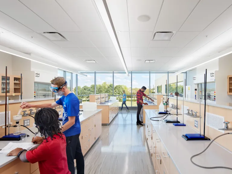 Alford chemistry lab featuring students working at light wood and white counter spaces