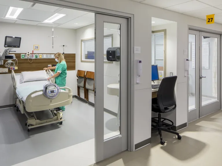 Interior, nurse making a post-operation room bed