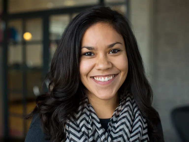 Shawna Foley smiling, wearing a black blouse and chevron scarf