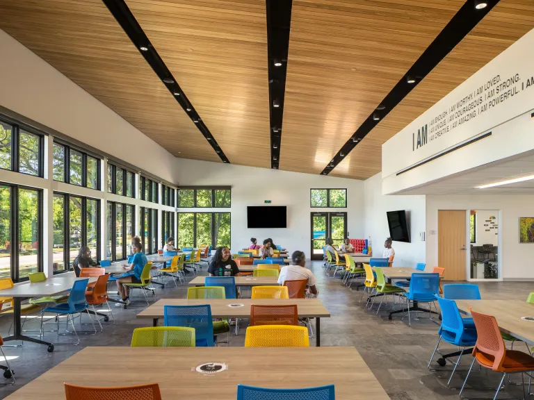 colorful community room with wood paneled ceiling