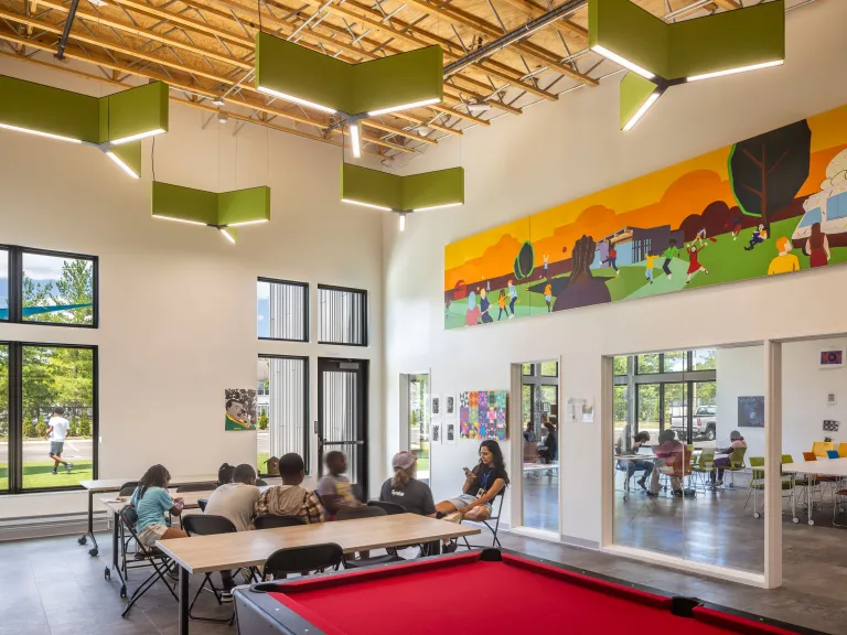 game room with sculptural light fixtures and colorful mural