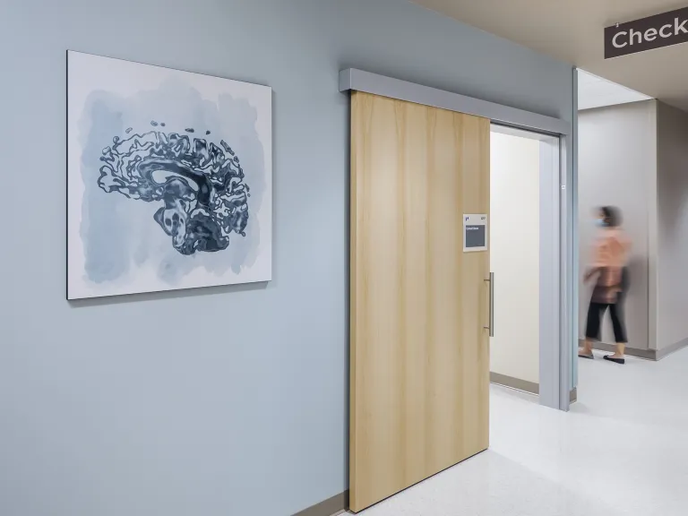 Blue painting of a brain scan in the hallway of a medical center.
