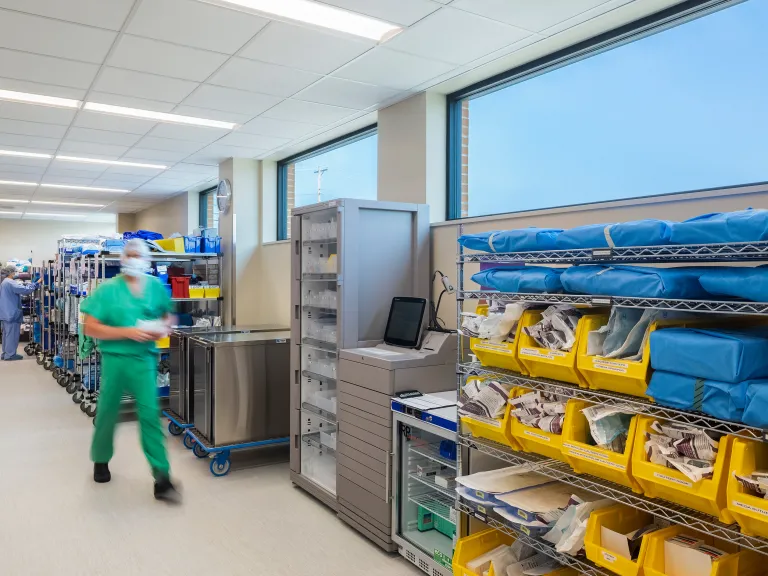 hospital staff walks through OR storage room