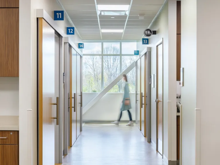 woman walks past corridor