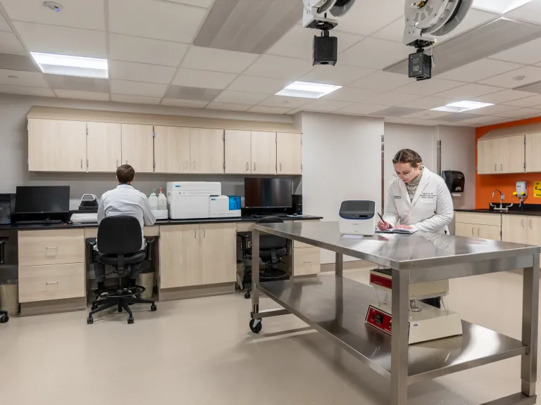 West Penn hospital laboratory with two people working with equipment.
