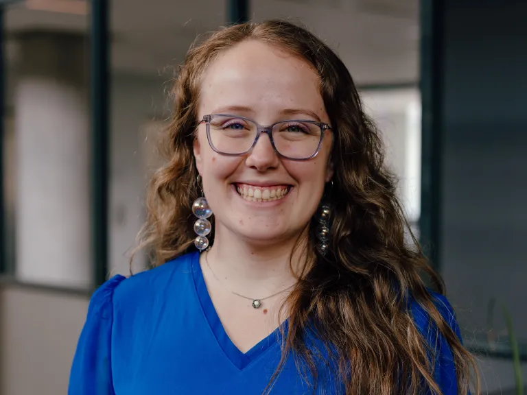 woman with glasses and wavy hair