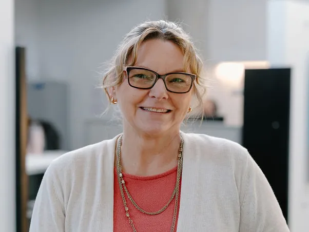 woman with glasses and white cardigan