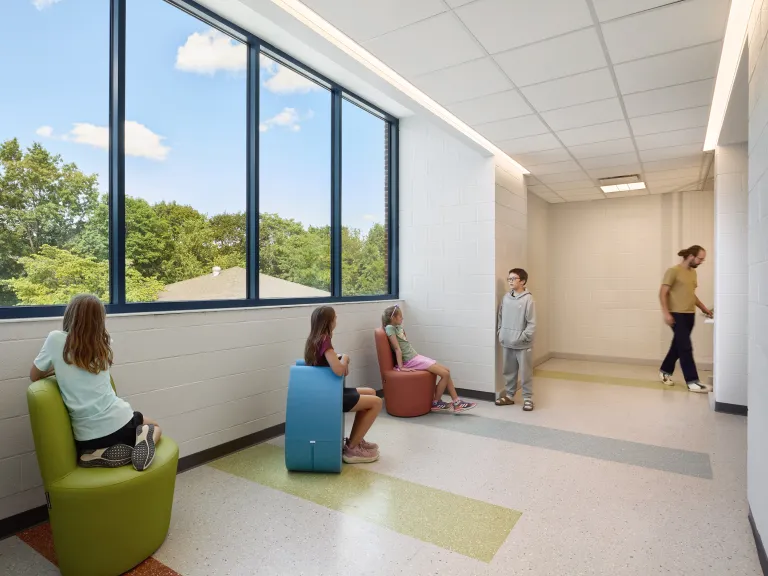 hallway with large window and children in colorful seats