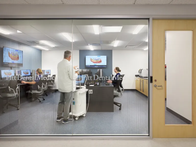 large window looking into classroom with computers